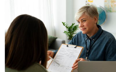Patient reviewing prescription assistance program paperwork with pharmacist