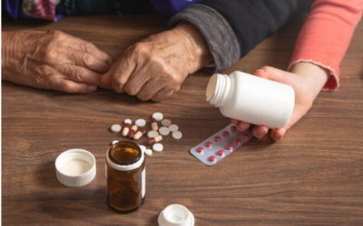 Senior couple reviewing prescription medication costs and paperwork at home